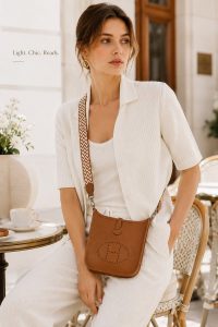 hermès mini evelyne gold brown togo leather crossbody bag – lightweight designer shoulder bag with detachable woven strap, minimalist everyday luxury